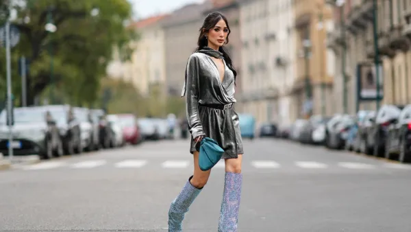 MILAN, ITALY - SEPTEMBER 20: Heart Evangelista wears a gray satin shiny / silver / lustrous gathered puffy mini / short dress, a blue bag, knee-high sequin shiny pointed boots, outside Alberta Ferretti, during the Milan Fashion Week - Womenswear Spring/Summer 2024 on September 20, 2023 in Milan, Italy. (Photo by Edward Berthelot/Getty Images)