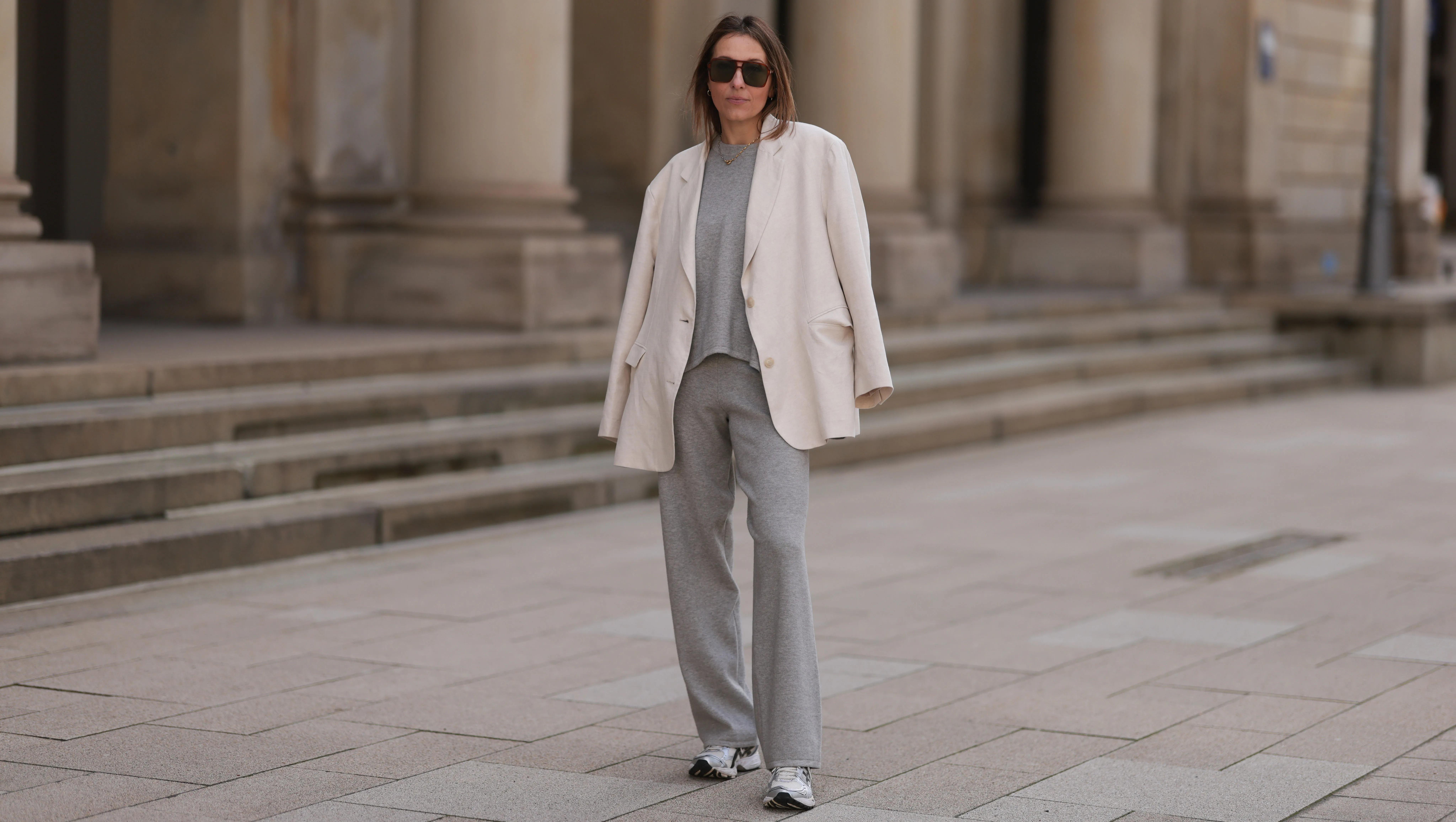 HAMBURG, GERMANY - APRIL 20: Elise Seitz seen wearing brown vintage aviator sunglasses, Soho Studios light grey wool knit sweater, matching Soho Studios light grey wool knit jogger pants, Soho Studios creamy white oversized blazer jacket and ASICS white / silver sneakers, on April 20, 2024 in Hamburg, Germany. (Photo by Jeremy Moeller/Getty Images)