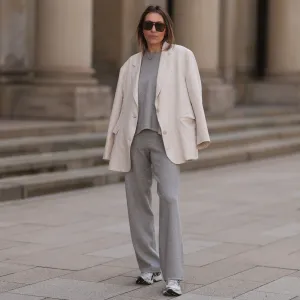 HAMBURG, GERMANY - APRIL 20: Elise Seitz seen wearing brown vintage aviator sunglasses, Soho Studios light grey wool knit sweater, matching Soho Studios light grey wool knit jogger pants, Soho Studios creamy white oversized blazer jacket and ASICS white / silver sneakers, on April 20, 2024 in Hamburg, Germany. (Photo by Jeremy Moeller/Getty Images)
