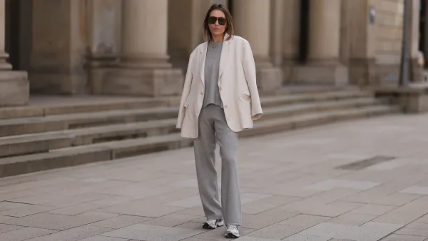 HAMBURG, GERMANY - APRIL 20: Elise Seitz seen wearing brown vintage aviator sunglasses, Soho Studios light grey wool knit sweater, matching Soho Studios light grey wool knit jogger pants, Soho Studios creamy white oversized blazer jacket and ASICS white / silver sneakers, on April 20, 2024 in Hamburg, Germany. (Photo by Jeremy Moeller/Getty Images)