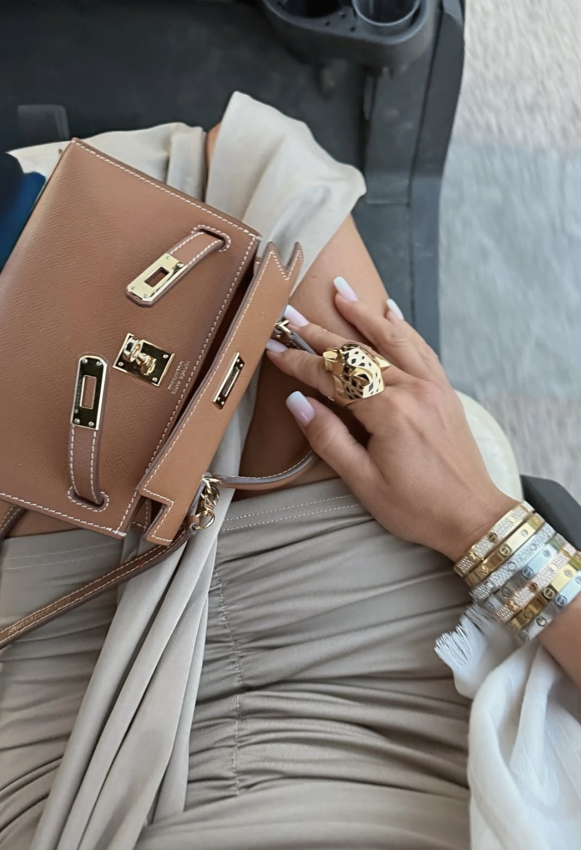 gold hermes mini kelly with cartier bracelet stack