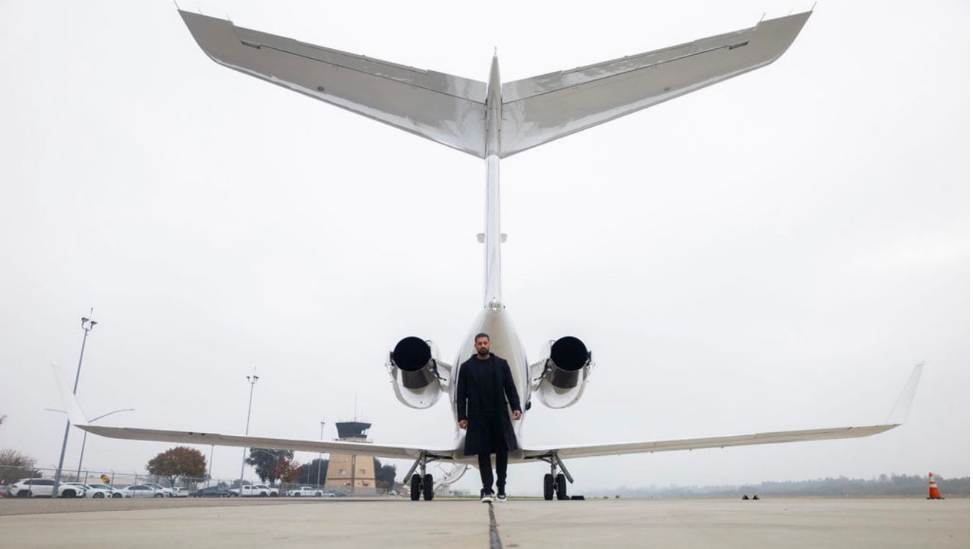 Amrinder Kamboj entrepreneur and founder of Kamboj Advisory in front of a plane