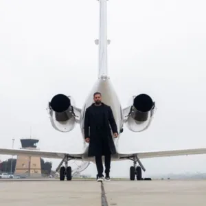 Amrinder Kamboj entrepreneur and founder of Kamboj Advisory in front of a plane