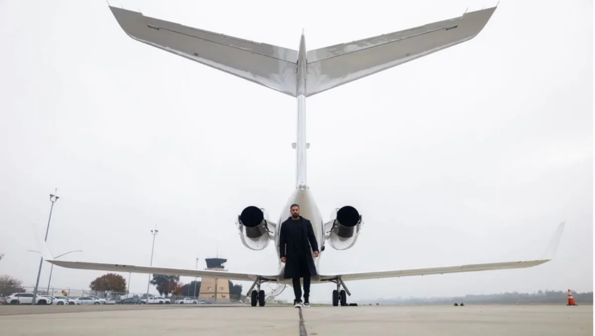 Amrinder Kamboj entrepreneur and founder of Kamboj Advisory in front of a plane