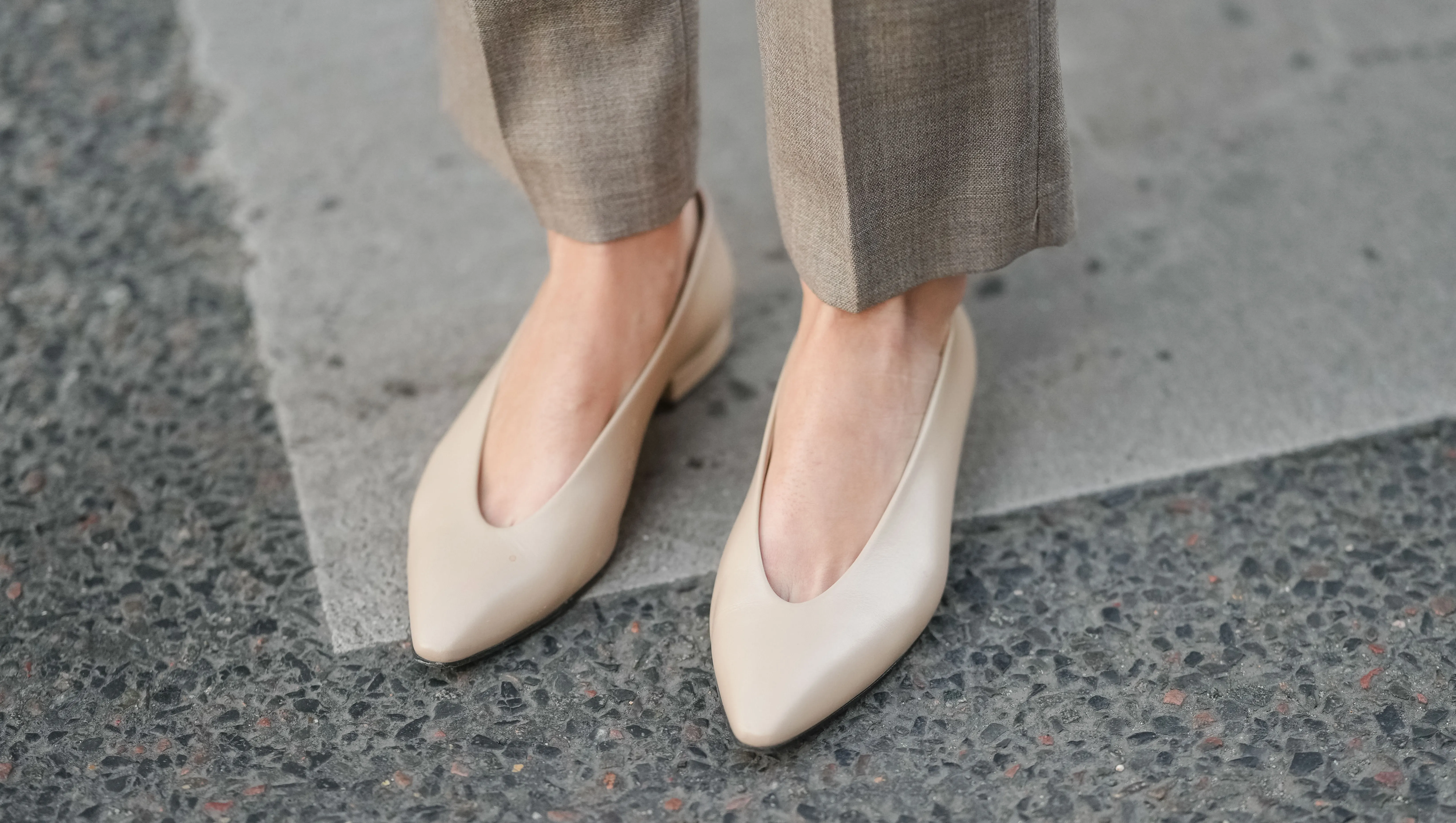 PARIS, FRANCE - MARCH 25: A close-up of beige pointed-toe leather pumps worn with taupe wool trousers, during a street style fashion photo session on March 25, 2025 in Paris, France. (Photo by Edward Berthelot/Getty Images)
