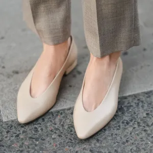 PARIS, FRANCE - MARCH 25: A close-up of beige pointed-toe leather pumps worn with taupe wool trousers, during a street style fashion photo session on March 25, 2025 in Paris, France. (Photo by Edward Berthelot/Getty Images)