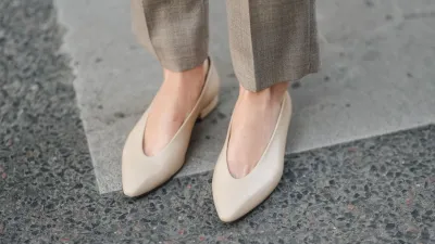 PARIS, FRANCE - MARCH 25: A close-up of beige pointed-toe leather pumps worn with taupe wool trousers, during a street style fashion photo session on March 25, 2025 in Paris, France. (Photo by Edward Berthelot/Getty Images)