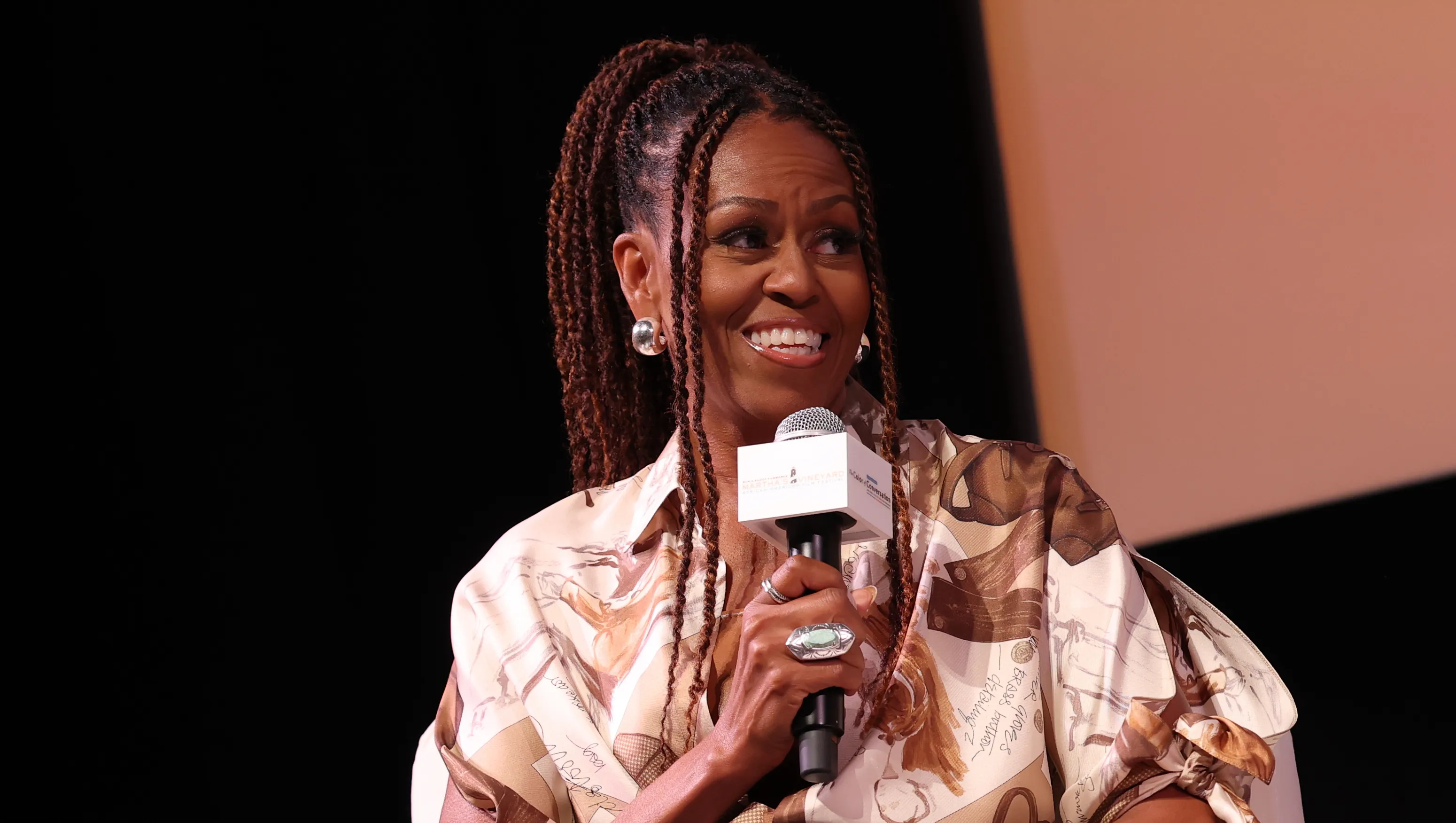 MARTHA'S VINEYARD, MASSACHUSETTS - AUGUST 09: Michelle Obama speaks during Higher Ground's "IMO with Michelle Obama & Craig Robinson" podcast during 2025 Martha's Vineyard African American Film Festival at Martha's Vineyard Performing Arts Center on August 09, 2025 in Martha's Vineyard, Massachusetts. (Photo by Arturo Holmes/Getty Images)