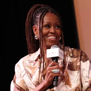 MARTHA'S VINEYARD, MASSACHUSETTS - AUGUST 09: Michelle Obama speaks during Higher Ground's "IMO with Michelle Obama & Craig Robinson" podcast during 2025 Martha's Vineyard African American Film Festival at Martha's Vineyard Performing Arts Center on August 09, 2025 in Martha's Vineyard, Massachusetts. (Photo by Arturo Holmes/Getty Images)
