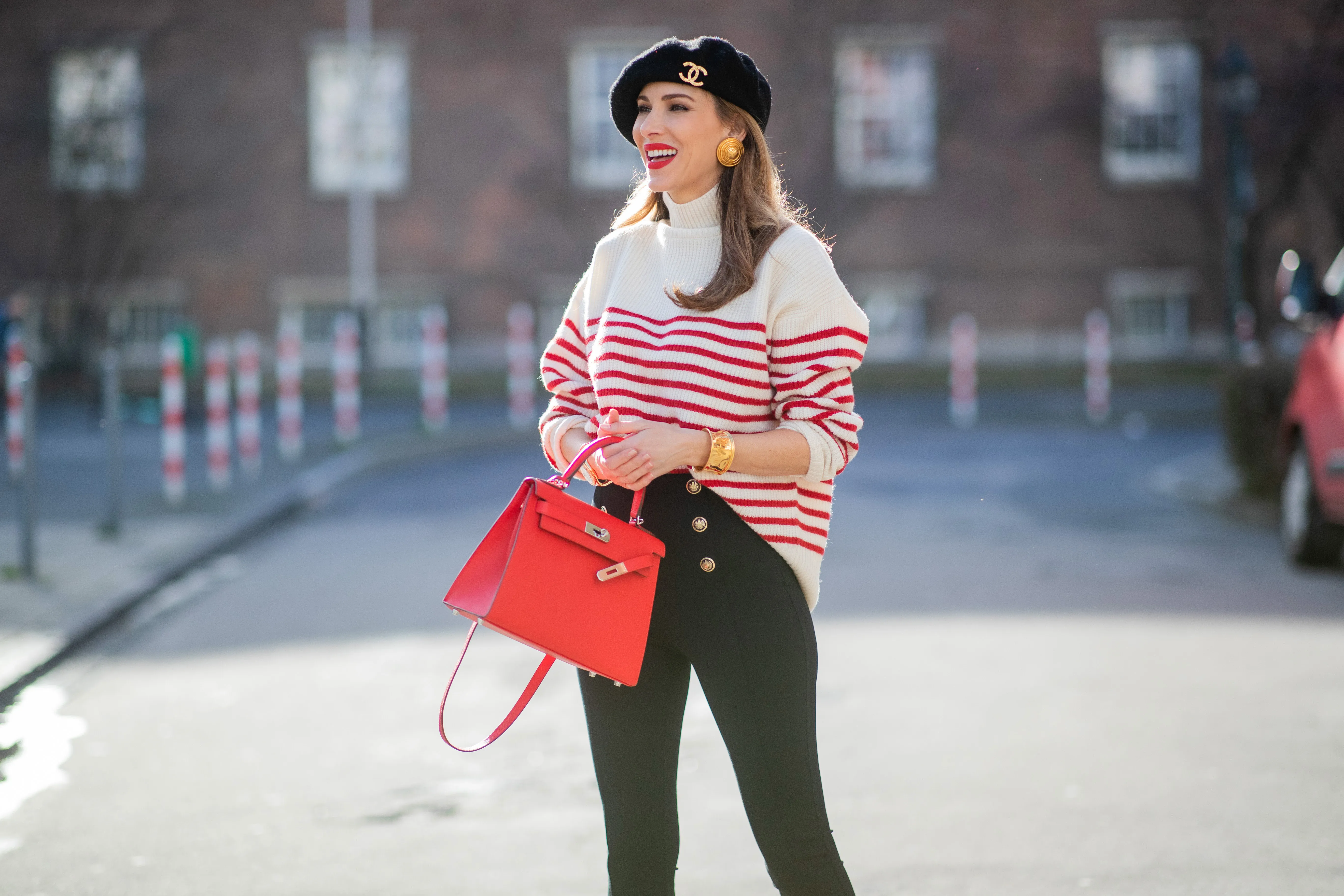 Alexandra Lapp is seen wearing ZARA striped knit jumper in red and white, CHANEL beret cap in black, ESCADA ear clips in gold, CHANEL vintage bracelet in gold, ZARA high waist trousers with golden buttons, HERM&Egrave;S Kelly 28 bag in red, vintage Rolex Yachtmaster Yacht-Master Yellow Gold 40 mm double dial, Tiffany T Square bangle in rose-gold on February 06, 2021 in Dusseldorf, Germany.