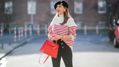 Alexandra Lapp is seen wearing ZARA striped knit jumper in red and white, CHANEL beret cap in black, ESCADA ear clips in gold, CHANEL vintage bracelet in gold, ZARA high waist trousers with golden buttons, HERMÈS Kelly 28 bag in red, vintage Rolex Yachtmaster Yacht-Master Yellow Gold 40 mm double dial, Tiffany T Square bangle in rose-gold on February 06, 2021 in Dusseldorf, Germany.