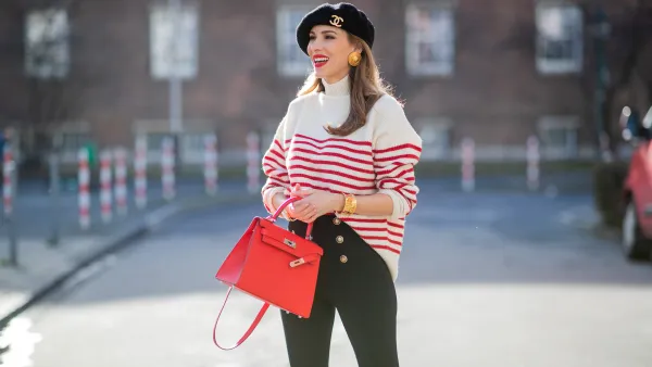 Alexandra Lapp is seen wearing ZARA striped knit jumper in red and white, CHANEL beret cap in black, ESCADA ear clips in gold, CHANEL vintage bracelet in gold, ZARA high waist trousers with golden buttons, HERMÈS Kelly 28 bag in red, vintage Rolex Yachtmaster Yacht-Master Yellow Gold 40 mm double dial, Tiffany T Square bangle in rose-gold on February 06, 2021 in Dusseldorf, Germany.