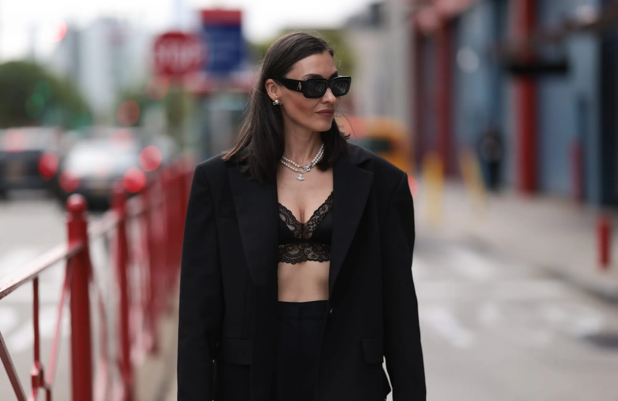NEW YORK,NEW YORK - SEPTEMBER 13: Yana Echko is seen wearing black sunglasses from The Attico, pear ear studs and two pearl necklaces from Vivienne Westwood, a black transformer suit from YANA BESFAMILNAYA with cut-outs on the legs, underneath black lace shorts from Edikted, a black lace bra top from Adore me, a black leather bag from Miu Miu, a large silber ring in heart shape on September 13, 2023 in New York City. (Photo by Jeremy Moeller/Getty Images)