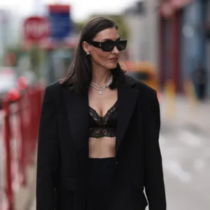 NEW YORK,NEW YORK - SEPTEMBER 13: Yana Echko is seen wearing black sunglasses from The Attico, pear ear studs and two pearl necklaces from Vivienne Westwood, a black transformer suit from YANA BESFAMILNAYA with cut-outs on the legs, underneath black lace shorts from Edikted, a black lace bra top from Adore me, a black leather bag from Miu Miu, a large silber ring in heart shape on September 13, 2023 in New York City. (Photo by Jeremy Moeller/Getty Images)