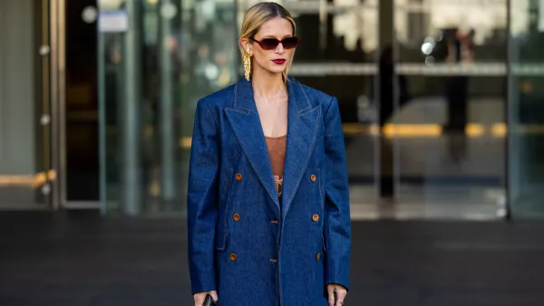 Helena Bordon wears denim blazer, brown dress, sunglasses, golden earrings outside Zimmermann during the Womenswear Fall/Winter 2024/2025 as part of Paris Fashion Week on March 04, 2024 in Paris, France.