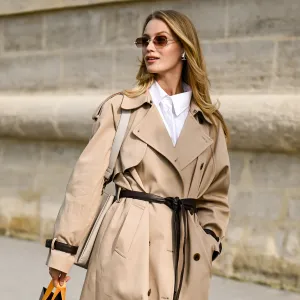 Jana Hakkinen is seen wearing a tan trench coat with belt, white shirt, gray bag and eyewear outside the Dior show during the Womenswear Spring Summer 2026 as part of Paris Fashion Week on October 01, 2025 in Paris, France.