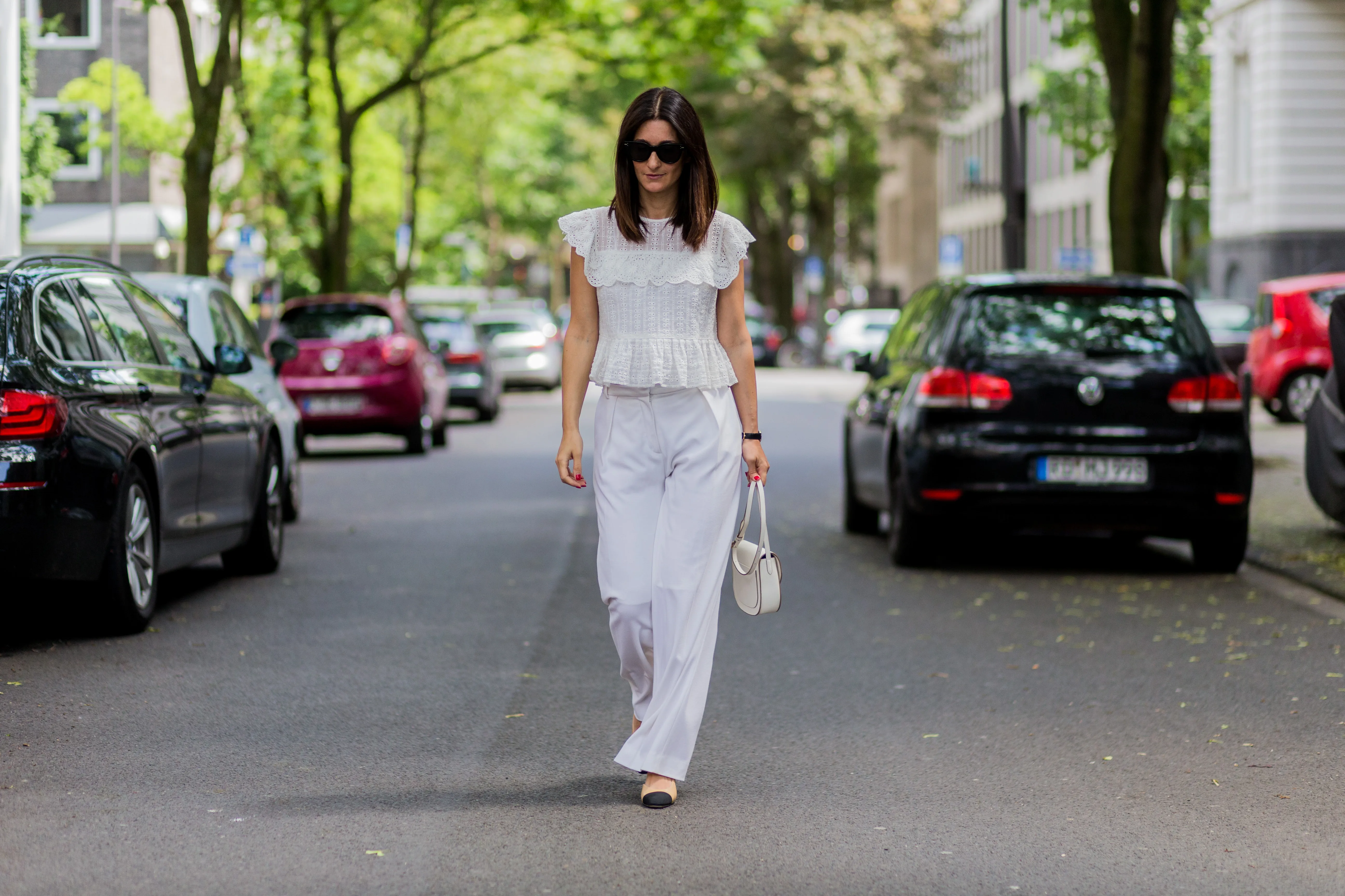 COLOGNE, GERMANY - JUNE 2: Golestaneh Mayer-Uellner wearing a white Zara lace top, wide leg pants from Fall Winter Spring Summer (FWSS), Slingbacks from Chanel as shoes, white Celine bag and sunglasses on June 2, 2016 in Cologne, Germany. (Photo by Christian Vierig/Getty Images)
