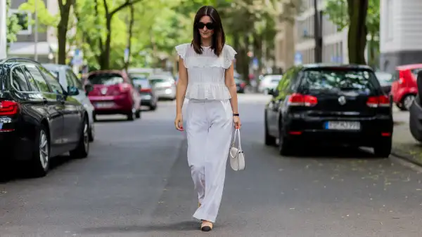 COLOGNE, GERMANY - JUNE 2: Golestaneh Mayer-Uellner wearing a white Zara lace top, wide leg pants from Fall Winter Spring Summer (FWSS), Slingbacks from Chanel as shoes, white Celine bag and sunglasses on June 2, 2016 in Cologne, Germany. (Photo by Christian Vierig/Getty Images)
