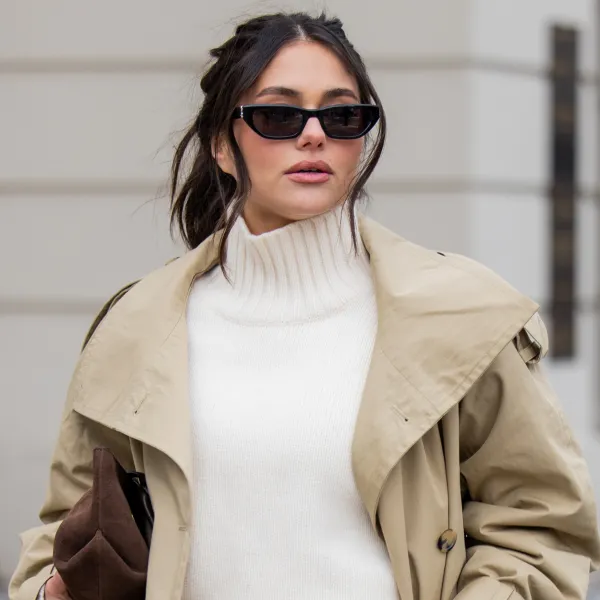 BERLIN, GERMANY - FEBRUARY 01: Aylin Sengül wears white jeans & beige trench coat Arket, turtleneck Cos, sunglasses YSL, loafers H&M, brown suede bag Demellier London during the Berlin Fashion Week Autumn/Winter 2026 at on February 01, 2026 in Berlin, Germany. (Photo by Christian Vierig/Getty Images)