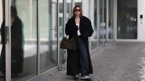 BERLIN, GERMANY - FEBRUARY 19: Sophia Geiss is seen wearing an oversized Bondi black coat layered over a fitted Black Palms top, styled with Acne Studios jeans in a relaxed, straight-leg silhouette. She completes the look with Alohas shoes, adding a clean and modern finish. Accessories include oversized Prada shades with bold frames and a Balenciaga Rodeo suede bag on February 19, 2026 in Berlin, Germany. (Photo by Jeremy Moeller/Getty Images)