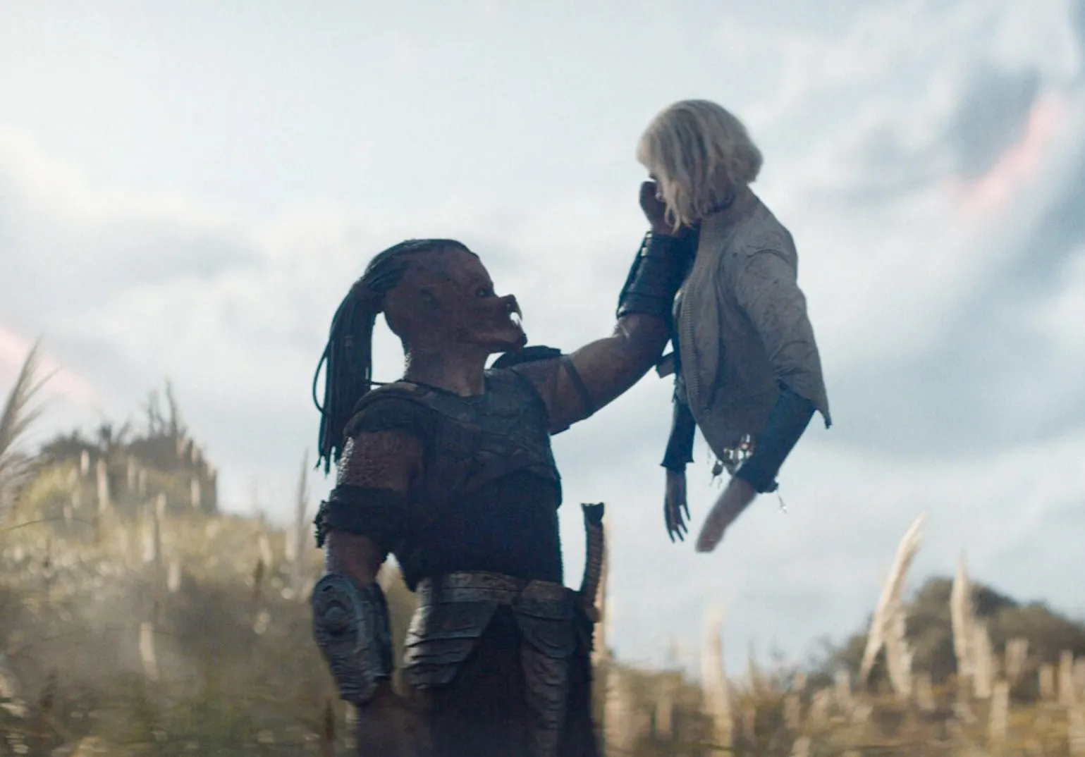 Dimitrius Schuster-Koloamatangi and Elle Fanning in Predator: Badlands