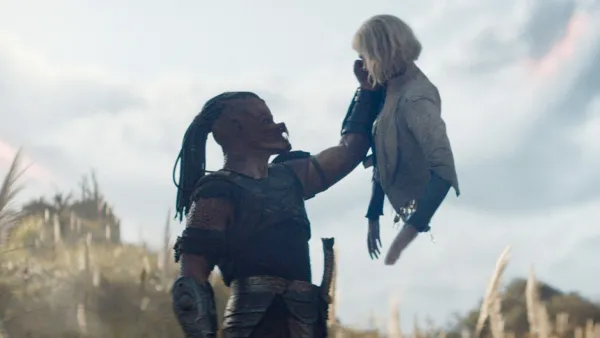 Dimitrius Schuster-Koloamatangi and Elle Fanning in Predator: Badlands