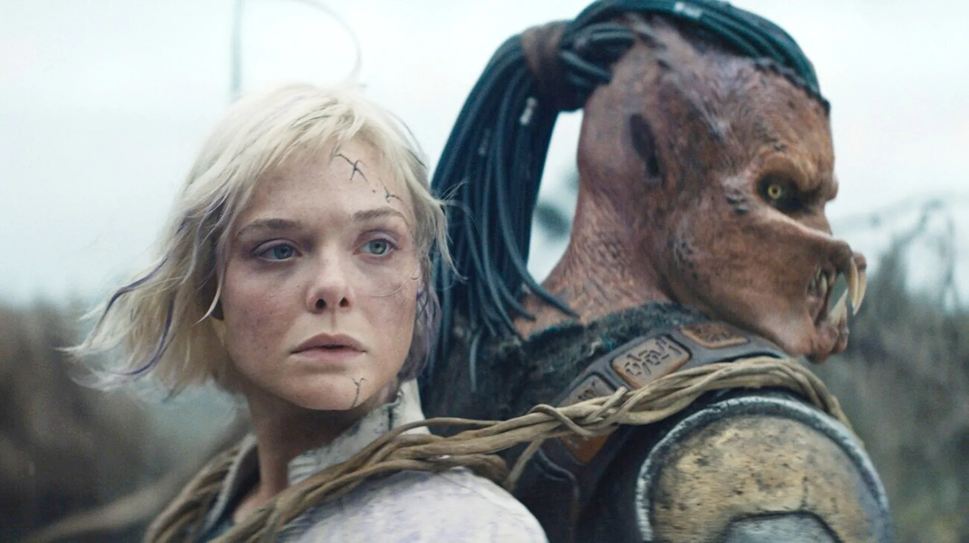 Elle Fanning and Dimitrius Schuster-Koloamatangi in Predator: Badlands
