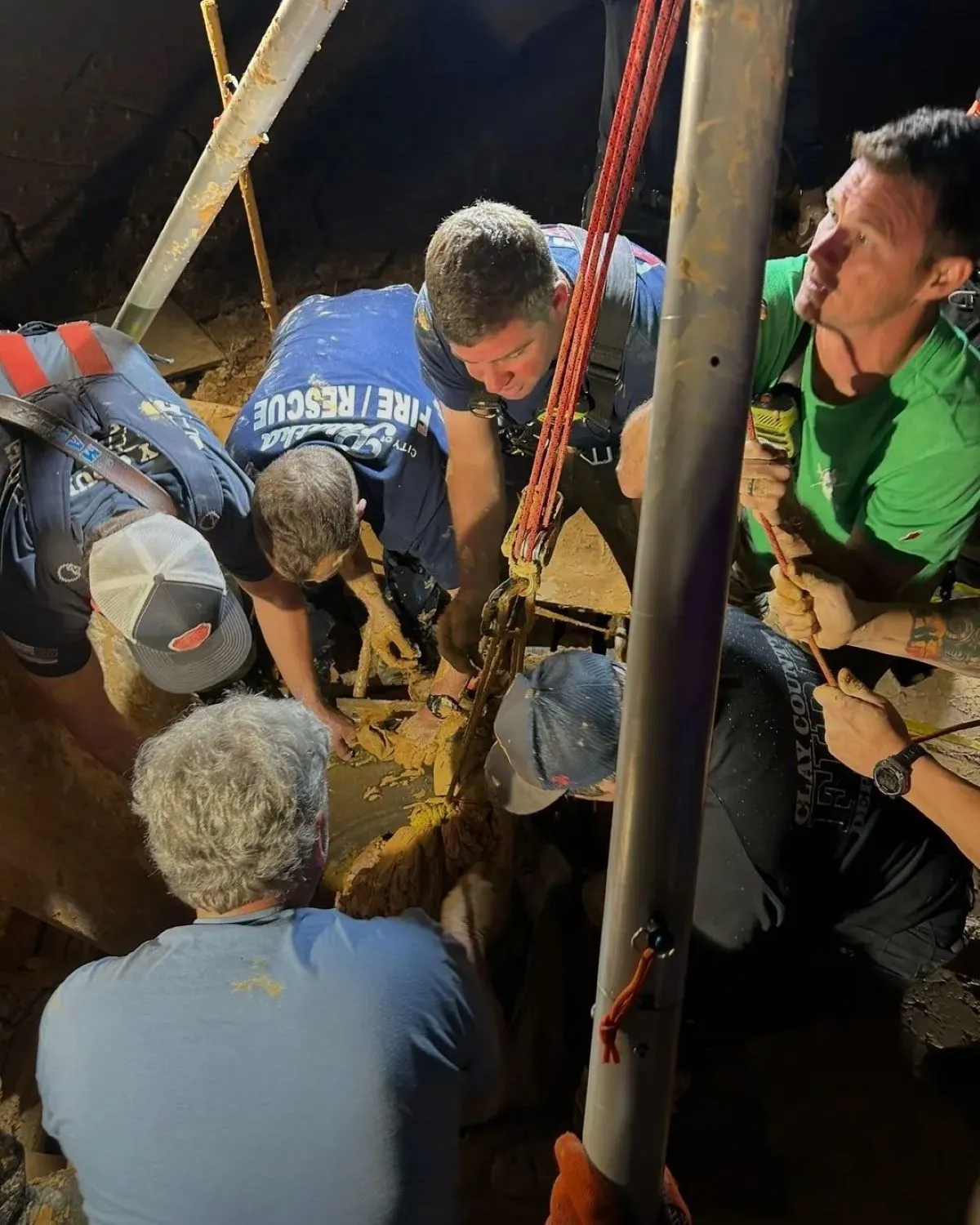A photo shows the rescue of a man stuck in mud