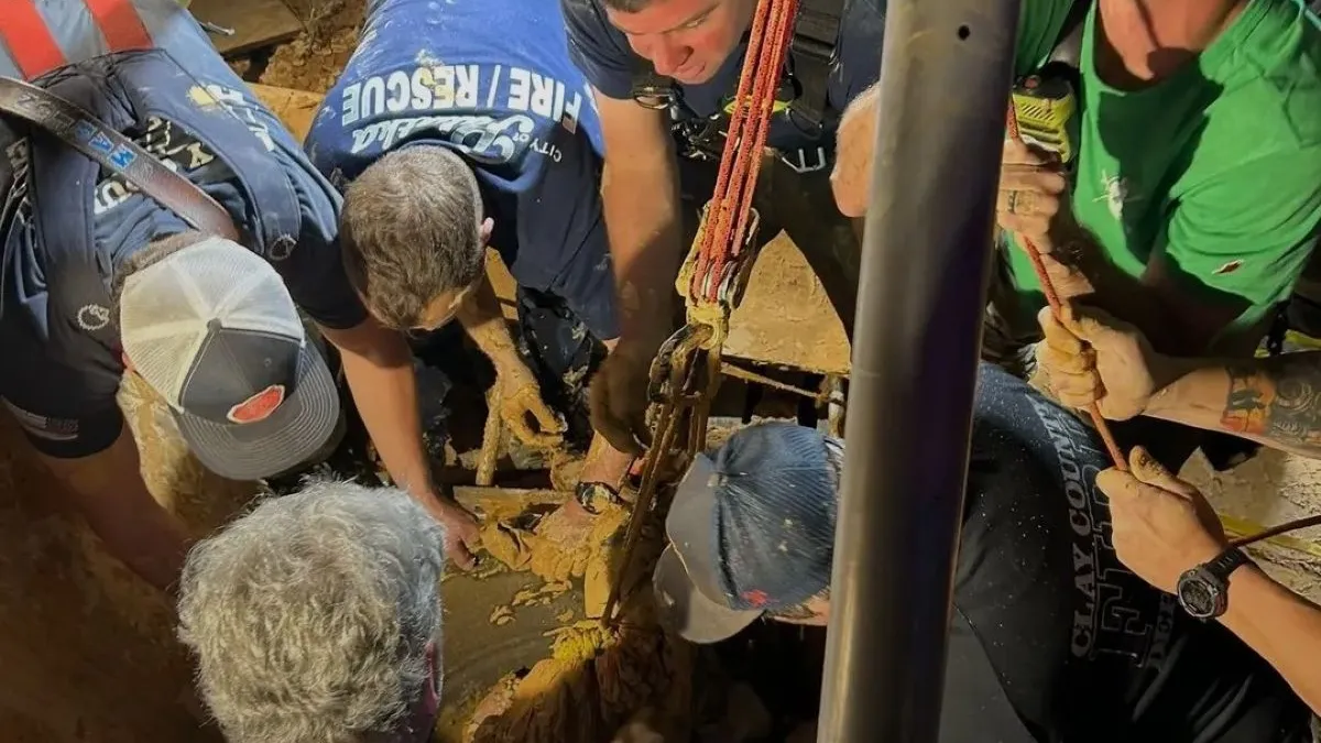 A photo shows the rescue of a man stuck in mud
