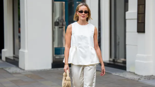 BERLIN, GERMANY - AUGUST 03: Tina Haase wears Zara butter yellow satin pants , Nakd beige ruffle top, Bottega Veneta beige jodie bag, white gold pointy heels on August 03, 2025 in Berlin, Germany. (Photo by Christian Vierig/Getty Images)