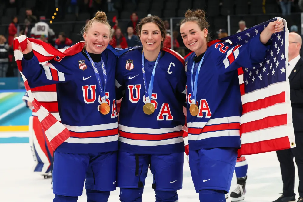 MILAN, ITALY - FEBRUARY 19: (L-R) Gold medalists Grace Zumwinkle #13, Hilary Knight #21 and Taylor Heise #27 of Team United States pose after the medal ceremony for Women's Ice Hockey following the Women's Gold Medal match between the United States and Canada on day 13 of the Milano Cortina 2026 Winter Olympic games at Milano Santagiulia Ice Hockey Arena on February 19, 2026 in Milan, Italy. (Photo by Bruce Bennett/Getty Images)