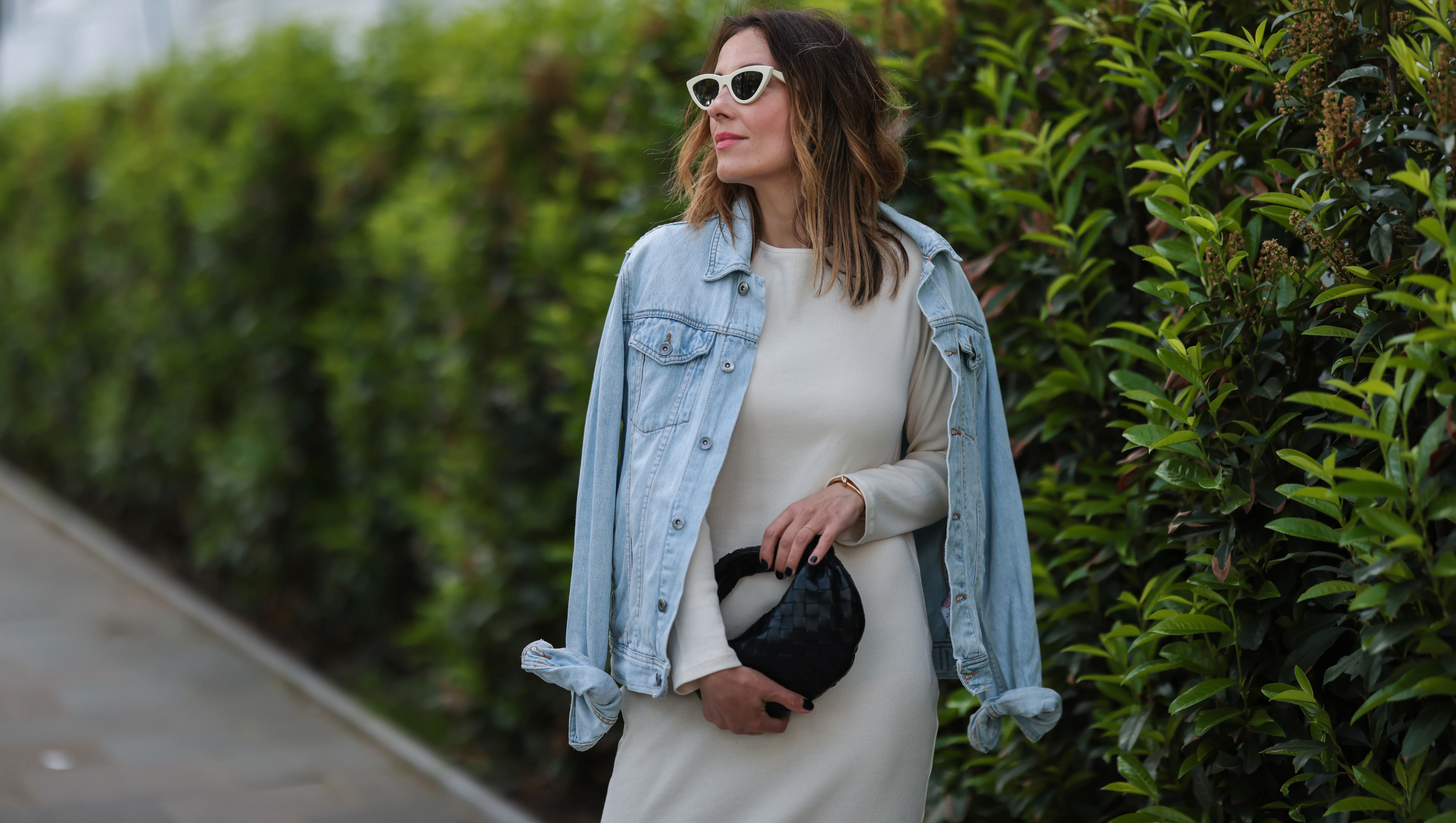 HAMBURG, GERMANY - JUNE 03: Elise Soho wearing beige Baige dress, blue Topman denim jacket and black Bottega Veneta mini leather bag on June 03, 2021 in Hamburg, Germany. (Photo by Jeremy Moeller/Getty Images)