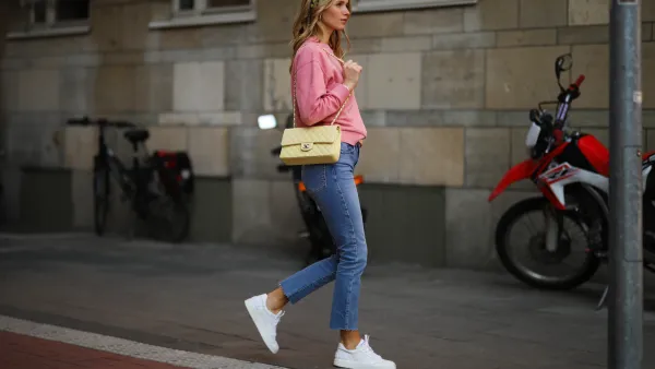 Scarlett Gartmann wearing pink Vogue sweater, Zara blue jeans, yellow H&M headband, yellow Chanel leather bag and white Chanel sneakers on March 24, 2021 in Dusseldorf, Germany.