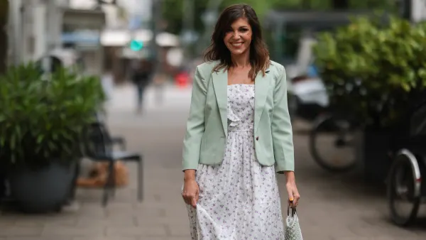 Anna Wolfers seen wearing a light green blazer, a long maxi dress with floral print and a white and light green crochet bag on June 02, 2022 in Hamburg, Germany.