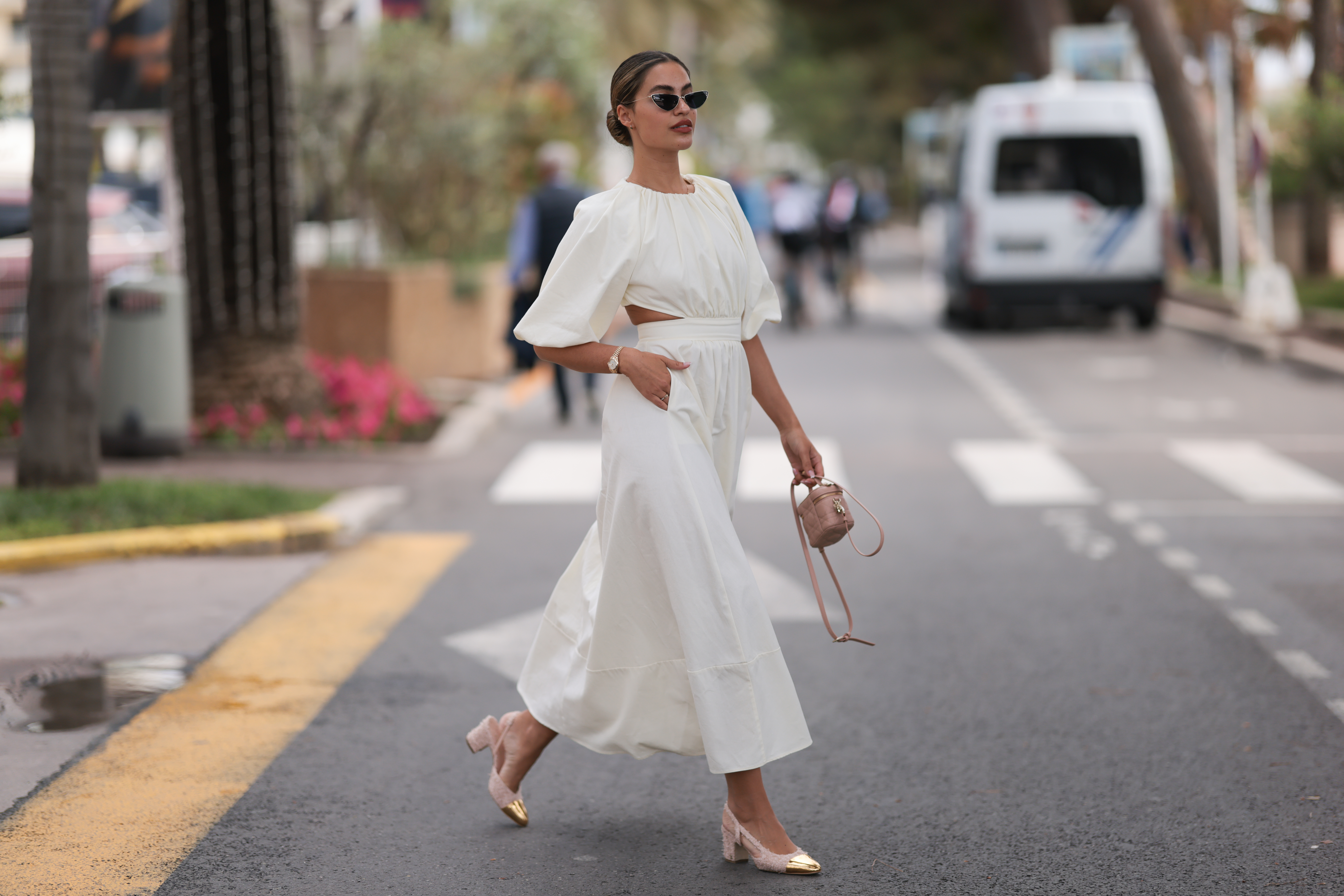 Jessica de Oliviera seen wearing Dior black sunglasses, Dior bag, Chanel heels, Rolex yellow gold watch and a flowy long dress with cutouts during the 76th Cannes film festival on May 21, 2023 in Cannes, France.