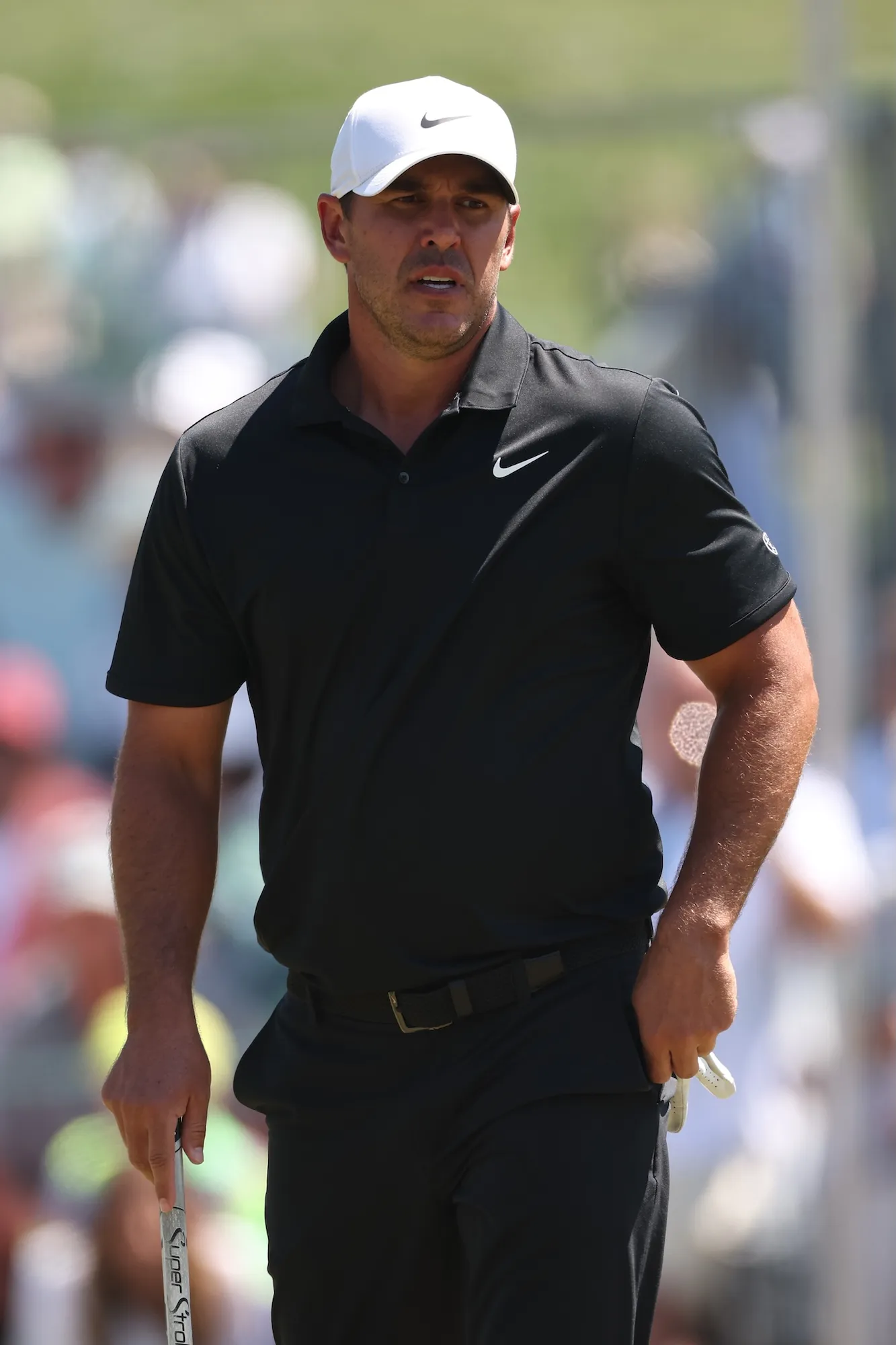 GettyImages-2267717697 Brooks Koepka consoles young girl trapped under golf cart