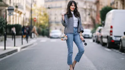 PARIS, FRANCE - MARCH 11: Sarah Benziane, fashion blogger, wears a Zara tweed checked jacket, a Zara white t-shirt, an Atelier Caesars multicolor bag, Newlook cropped blue denim jeans, and Newlook black shoes, on March 11, 2017 in Paris, France. (Photo by Edward Berthelot/Getty Images)