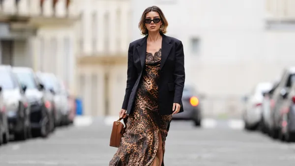 PARIS, FRANCE - APRIL 07: Katie Giorgadze wears a brown cheetah leopard print maxi dress with a slit and a lace neckline from L’agence, an oversize black blazer jacket from Mantu, suede brown Chypre sandals from Hermes, a Boomerang brown leather bag from Elleme, during a street style fashion photo session, on April 07, 2024 in Paris, France. (Photo by Edward Berthelot/Getty Images)