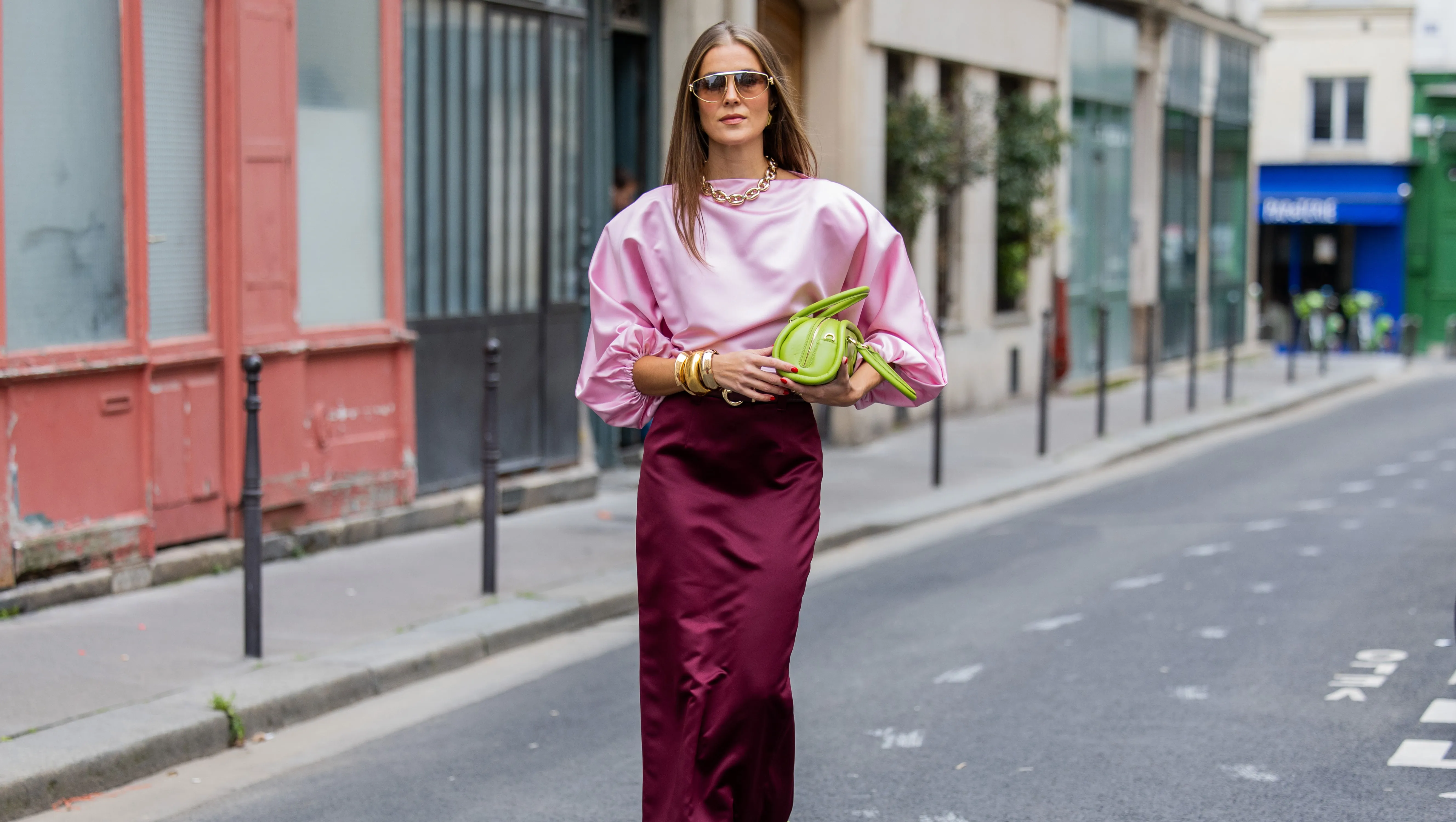 PARIS, FRANCE - SEPTEMBER 29: Nina Sandbech wears burgundy skirt and pink top homemade, green heels Prada, green bag Mietis, sunglasses Loewe during Womenswear Spring/Summer 2025 as part of Paris Fashion Week on September 29, 2024 in Paris, France. (Photo by Christian Vierig/Getty Images)