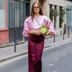 PARIS, FRANCE - SEPTEMBER 29: Nina Sandbech wears burgundy skirt and pink top homemade, green heels Prada, green bag Mietis, sunglasses Loewe during Womenswear Spring/Summer 2025 as part of Paris Fashion Week on September 29, 2024 in Paris, France. (Photo by Christian Vierig/Getty Images)