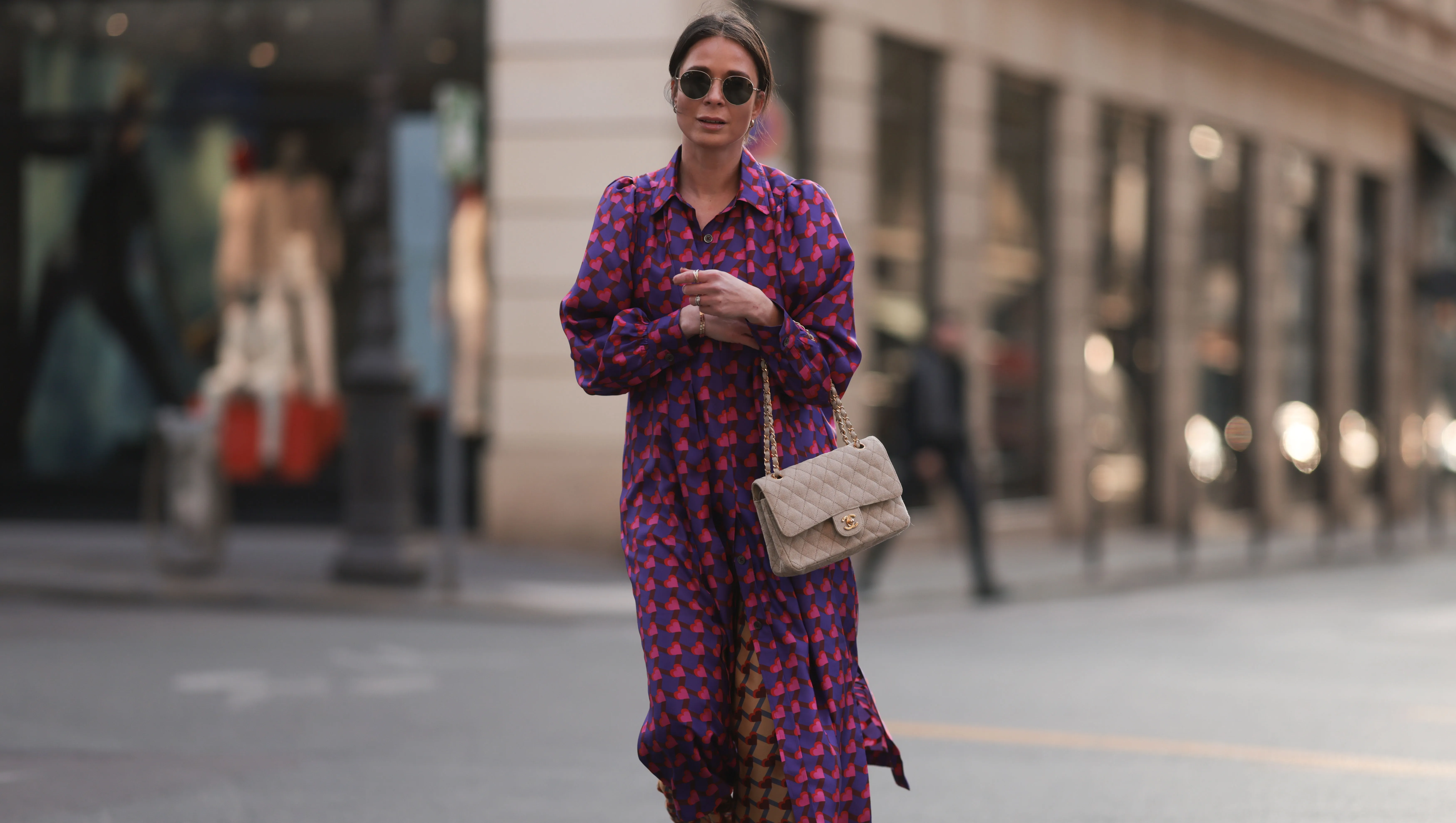 PARIS, FRANCE - MARCH 04: Patricia Wirschke seen wearing Ray-Ban gold round sunglasses, Odeeh purple / pink heart print pattern button maxi silk dress with long sleeves, Odeeh beige / red print pattern long silk pants, Chanel beige fabric flap bag, Chanel beige / black slingback leather heels / pumps, during Paris Fashion Week - Womenswear Fall Winter 2023 2024, on March 04, 2023 in Paris, France. (Photo by Jeremy Moeller/Getty Images)