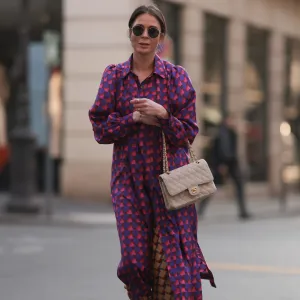 PARIS, FRANCE - MARCH 04: Patricia Wirschke seen wearing Ray-Ban gold round sunglasses, Odeeh purple / pink heart print pattern button maxi silk dress with long sleeves, Odeeh beige / red print pattern long silk pants, Chanel beige fabric flap bag, Chanel beige / black slingback leather heels / pumps, during Paris Fashion Week - Womenswear Fall Winter 2023 2024, on March 04, 2023 in Paris, France. (Photo by Jeremy Moeller/Getty Images)