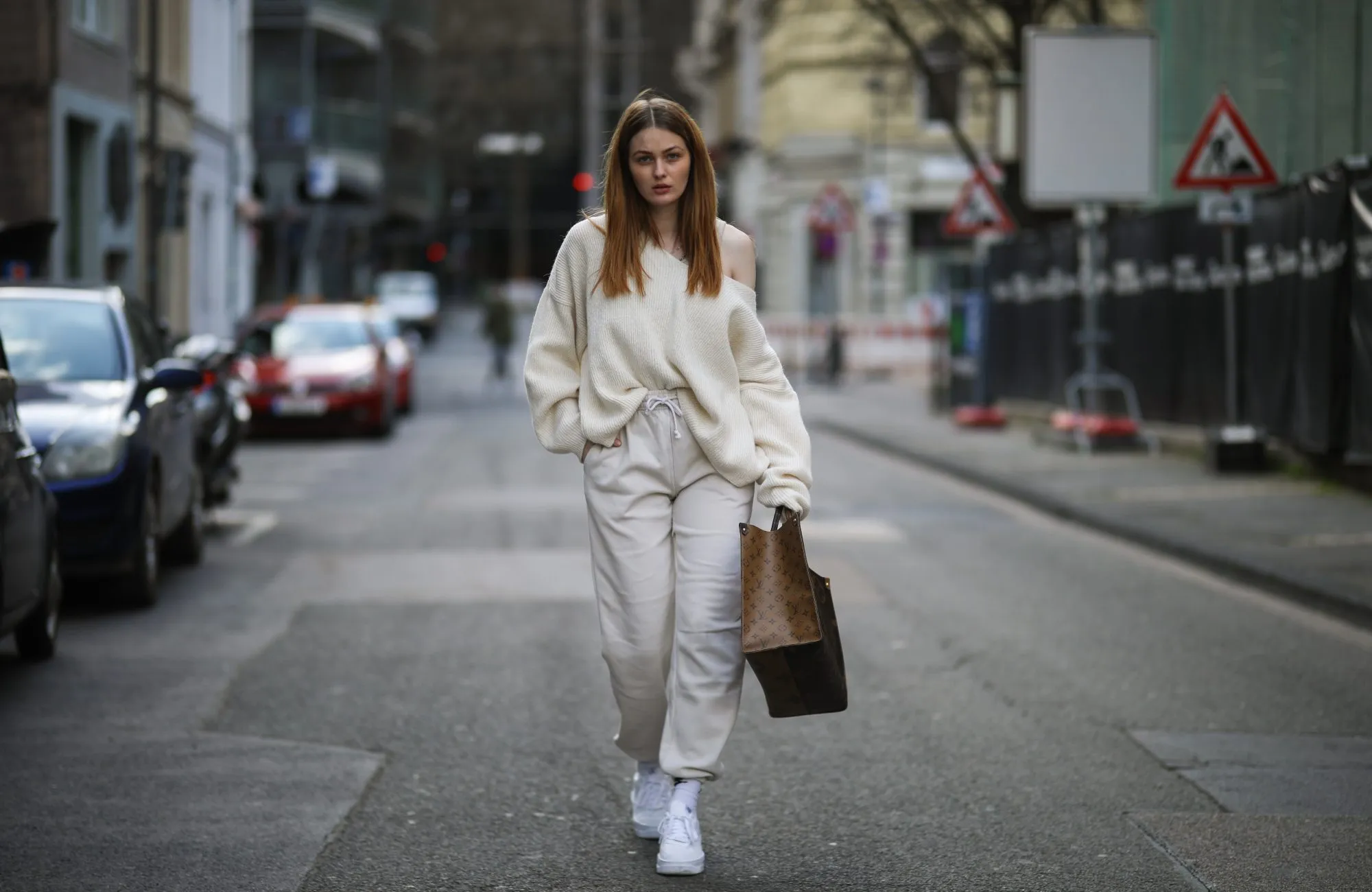 COLOGNE, GERMANY - MARCH 26: Vanessa Stanat wearing beige Zara sweater, Louis Vuitton On The Go brown monogram travel bag, beige Nike sweatpants, white Nike socks and Nike Air Force sneakers on March 26, 2021 in Cologne, Germany. (Photo by Jeremy Moeller/Getty Images)