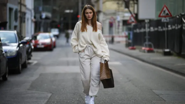 COLOGNE, GERMANY - MARCH 26: Vanessa Stanat wearing beige Zara sweater, Louis Vuitton On The Go brown monogram travel bag, beige Nike sweatpants, white Nike socks and Nike Air Force sneakers on March 26, 2021 in Cologne, Germany. (Photo by Jeremy Moeller/Getty Images)