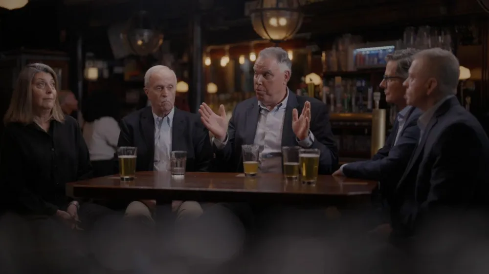 A group of former FBI agents is seated around a table