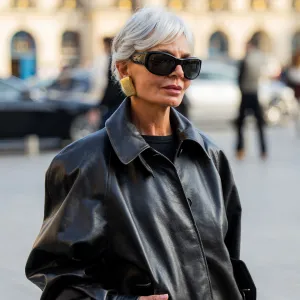 PARIS, FRANCE - MARCH 08: Grece Ghanem wears black leather jacket, skirt with slit, bag, sunglasses outside Magda Butrym during Day Seven of Paris Fashion Week - Womenswear Fall/Winter 2026/2027 on March 08, 2026 in Paris, France. (Photo by Christian Vierig/Getty Images)
