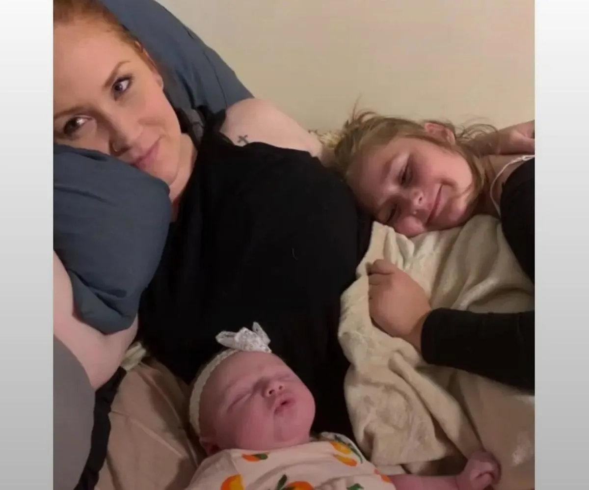 A photo of the mother and her two daughters