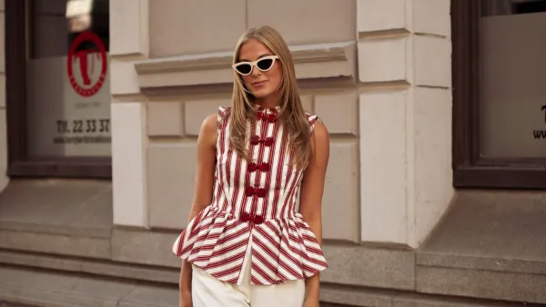 OSLO, NORWAY - AUGUST 26: Martine Akersveen wears white pants, red and white striped top and a beige bag outside the Christian Aks show during Oslo Fashion Week on August 26, 2025 in Oslo, Norway. (Photo by Raimonda Kulikauskiene/Getty Images)