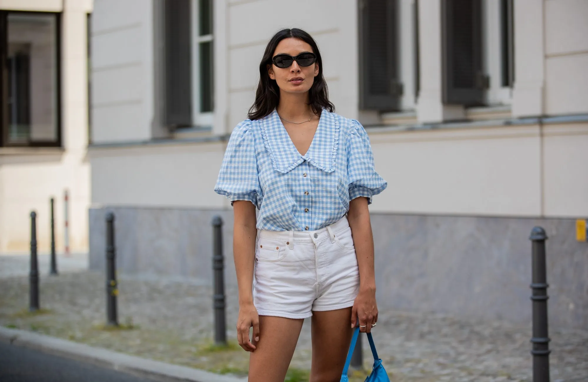 BERLIN, GERMANY - JUNE 14: Alyssa Cordes is seen wearing white shorts Levis, blue checkered top Envii, Adidas sneaker, Prada bag in blue, sunglasses Mango on June 14, 2021 in Berlin, Germany. (Photo by Christian Vierig/Getty Images)