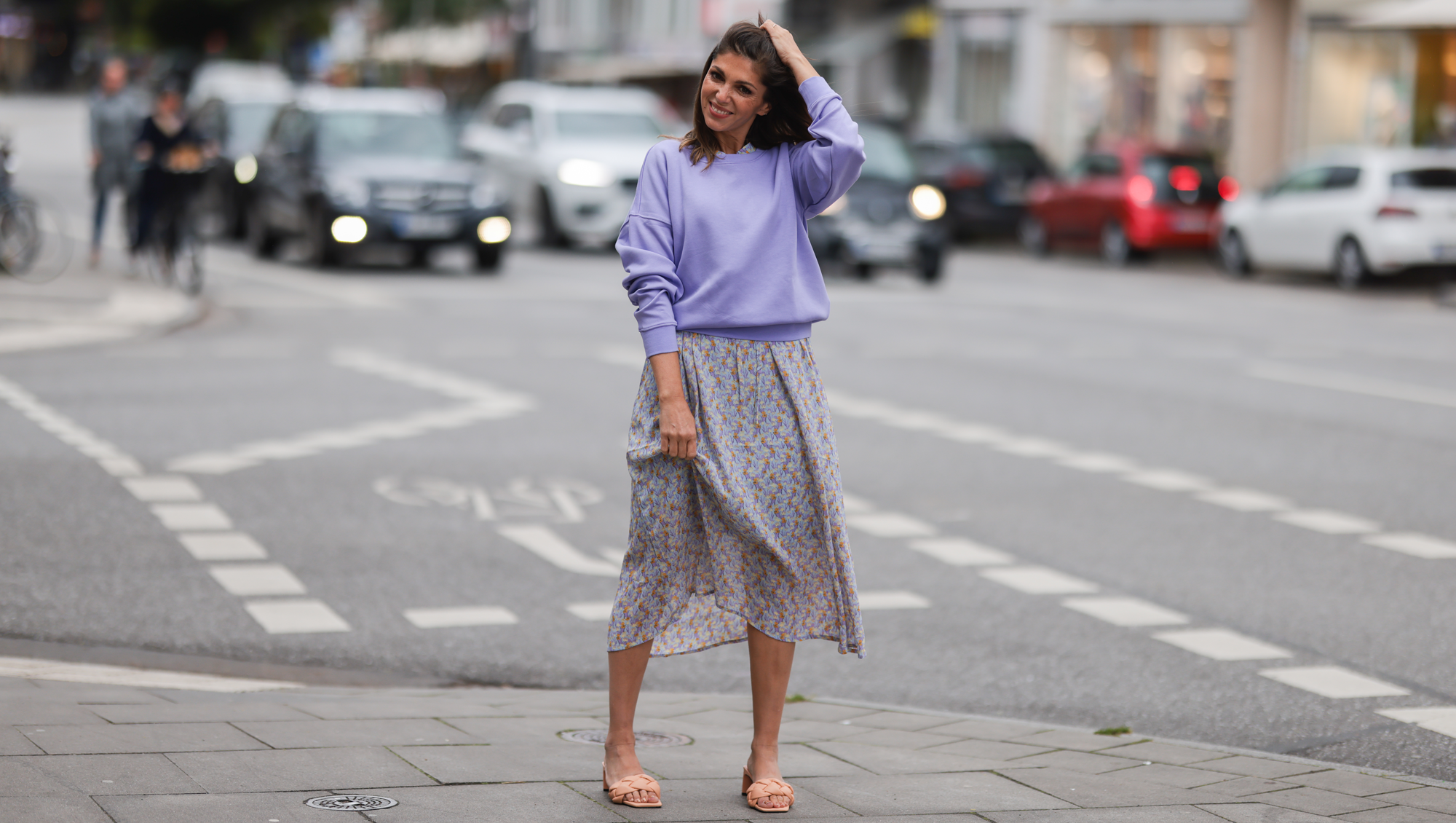 Anna Wolfers seen wearing a purple knit sweater, a light blue midi dress with floral print and light orange heels on June 02, 2022 in Hamburg, Germany.